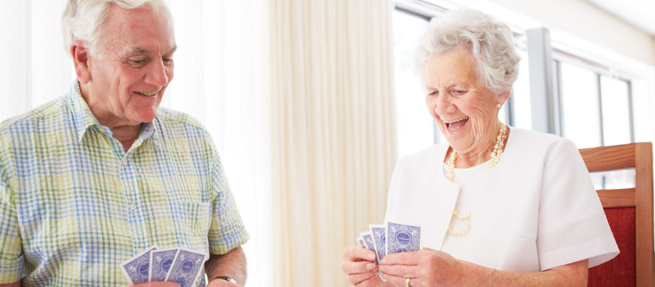elderly couple playing cards
